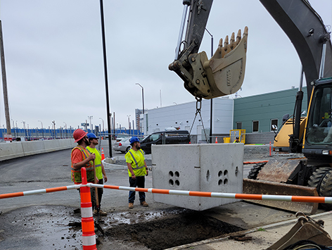 <b>Relocation of HEX manhole C19BA-203:</b>  Setting down the new replacement 4'x4'x4'D vault for manhole C19BA-203.