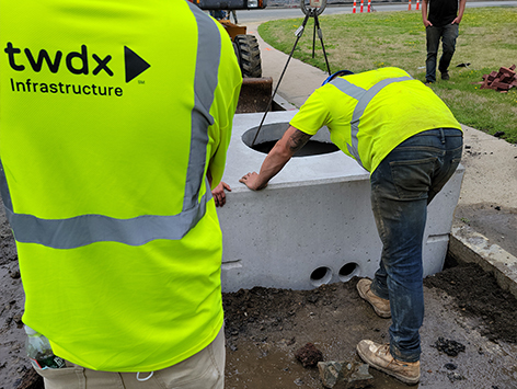 <b>Relocation of HEX manhole C19BA-203:</b>  Setting down the new replacement 4'x4'x4'D vault for manhole C19BA-203.