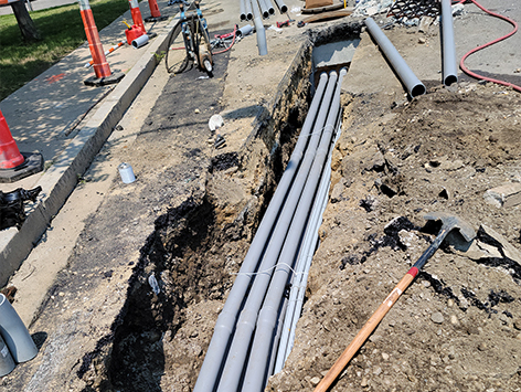 Installing (11) 4 inch ducts and (4) 1.25 inch ducts between HEX manholes C19BA-202 and relocated C19BA-203.