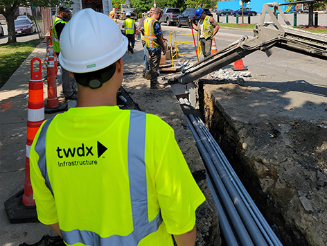 Encasing (11) 4 inch ducts and (4) 1.25 ducts between HEX manholes C19BA-202 and C19BA-203 with concrete.