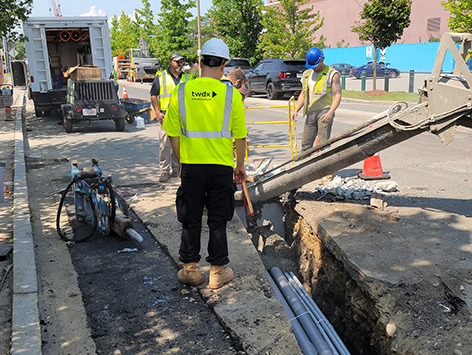 Encasing (11) 4 inch ducts and (4) 1.25 ducts between HEX manholes C19BA-202 and C19BA-203 with concrete.