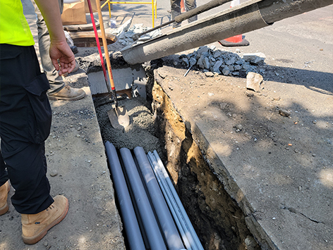 Encasing (11) 4 inch ducts and (4) 1.25 ducts between HEX manholes C19BA-202 and C19BA-203 with concrete.