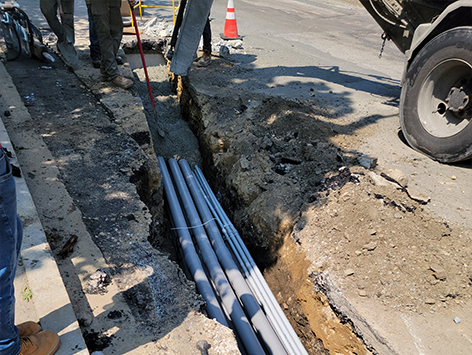 Encasing (11) 4 inch ducts and (4) 1.25 ducts between HEX manholes C19BA-202 and C19BA-203 with concrete.