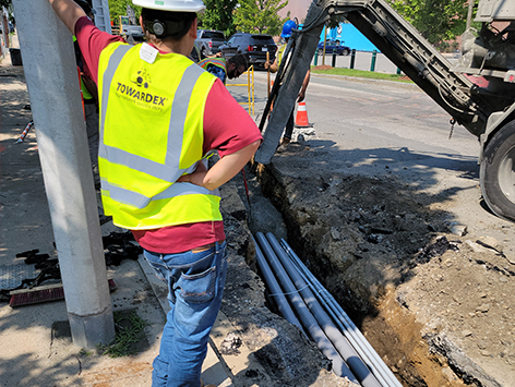 Encasing (11) 4 inch ducts and (4) 1.25 ducts between HEX manholes C19BA-202 and C19BA-203 with concrete.