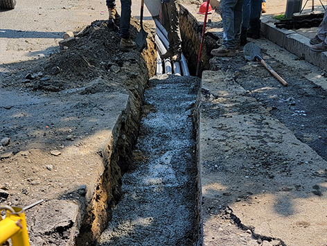 Encasing (11) 4 inch ducts and (4) 1.25 ducts between HEX manholes C19BA-202 and C19BA-203 with concrete.