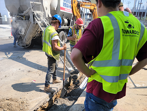 Encasing (11) 4 inch ducts and (4) 1.25 ducts between HEX manholes C19BA-202 and C19BA-203 with concrete.