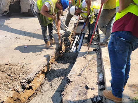 Encasing (11) 4 inch ducts and (4) 1.25 ducts between HEX manholes C19BA-202 and C19BA-203 with concrete.