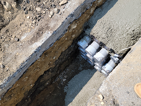 Backfilling of the completed mainline section with concrete.